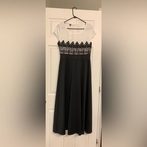 Women’s dress. Tee length. Never worn. Great for any occasion.   Black and white